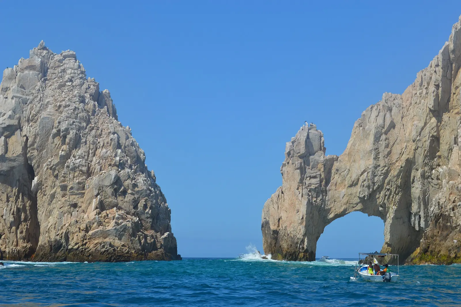 Rock arch at Land's End near Cabo San Lucas with a jet ski in the sea