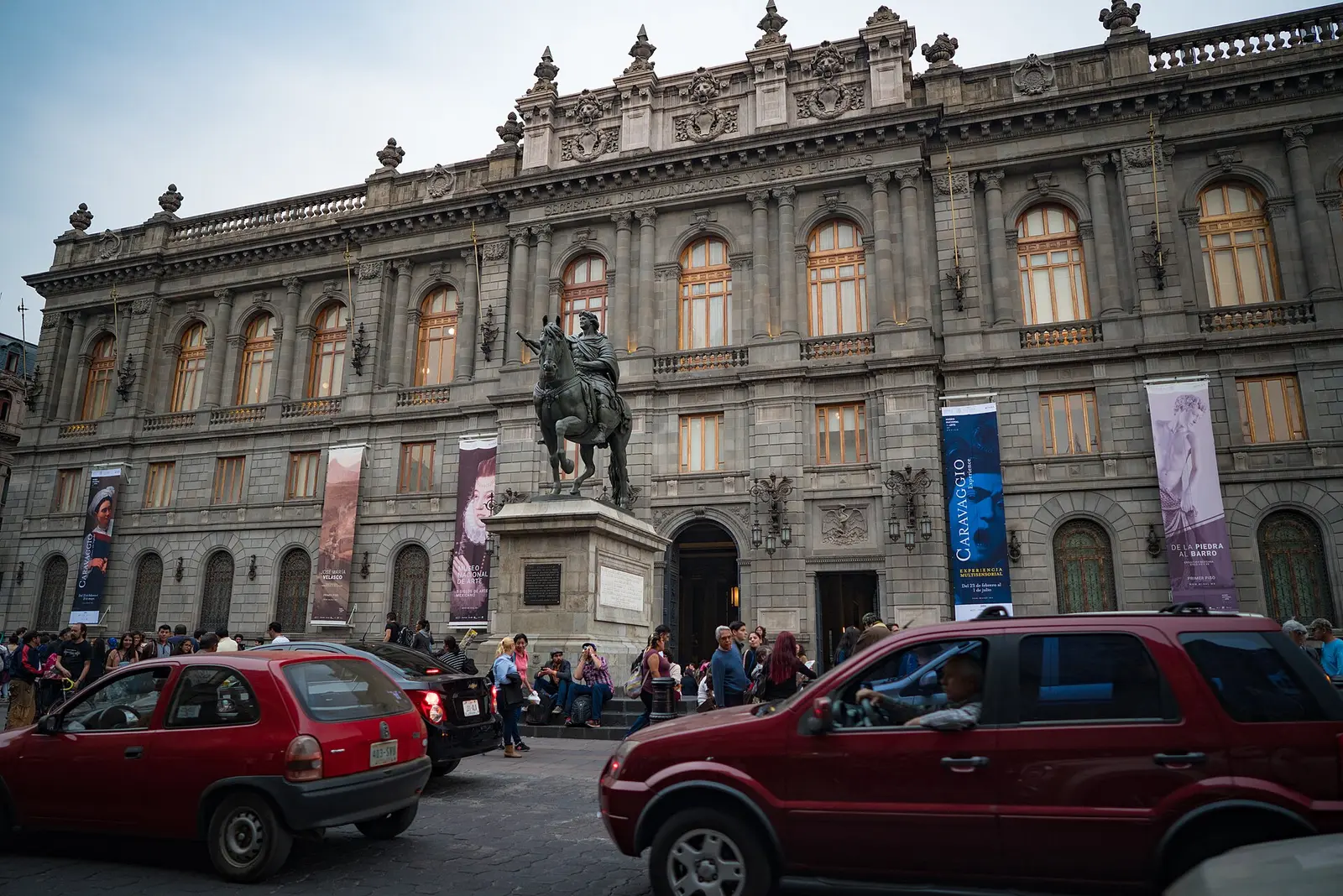 Ornate stone facade of the Museo Nacional de Arte MUNAL in Mexico City with an equestrian statue in front
