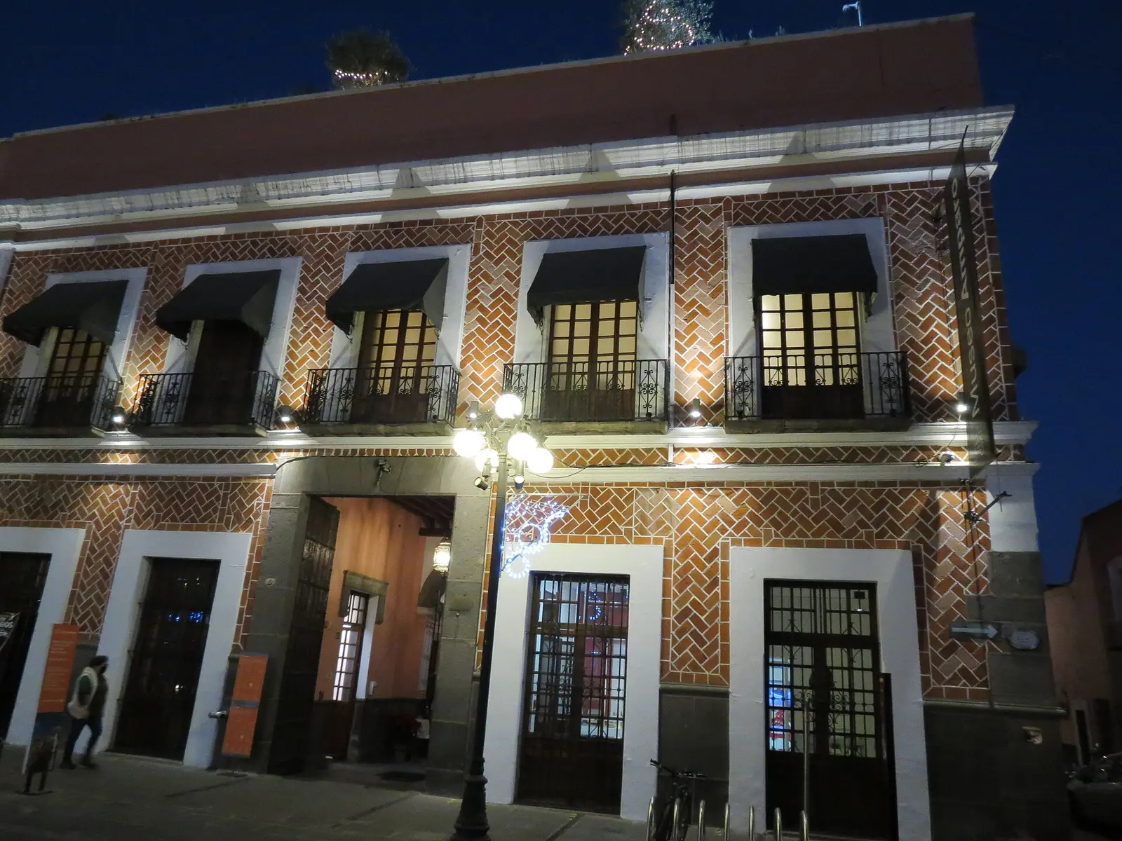 Colonial tiled facade of the Museo Amparo in Puebla lit at night